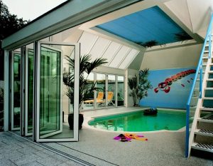 A bifold door opening into a swimming pool area